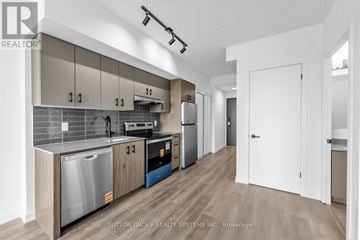 Burlington (Alton) condo for rent - A modern kitchen with wooden cabinets and stainless steel appliances.