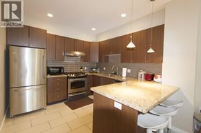 Vancouver townhouse for rent - A modern kitchen with a granite countertop and stainless steel appliances.