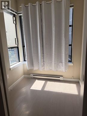 Vancouver townhouse for rent - A sunny bathroom with a window and a white shower curtain.