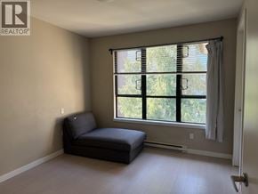 Vancouver townhouse for rent - A living room with a black sofa and a window with blinds.