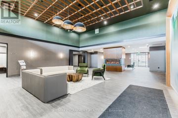 Hamilton (Waterdown) condo for rent - A modern living room with a grey sofa and a wooden coffee table.