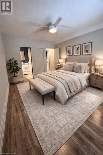 Mississauga condo for rent - A bedroom with a large bed and a bench in the middle.
