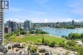 Vancouver apartment for rent - A cityscape with a baseball field in the foreground and a body of water in the background.