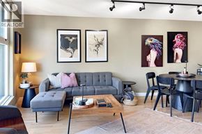 Vancouver apartment for rent - A living room with a grey sofa, a coffee table, and a dining table with chairs.