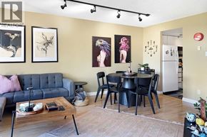 Vancouver apartment for rent - A living room with a grey couch, a coffee table, and a dining table set up.
