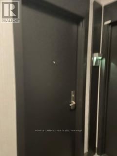 Mississauga (City Centre) condo for rent - A large indoor swimming pool with a hot tub in the middle of a spacious room with a view of a building outside.