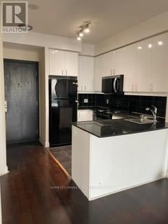 Mississauga (City Centre) condo for rent - A reception area with a large glass display case and a reception desk.