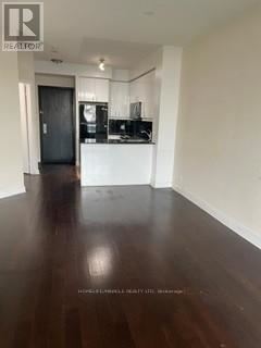 Mississauga (City Centre) condo for rent - A room with a black floor and white walls.