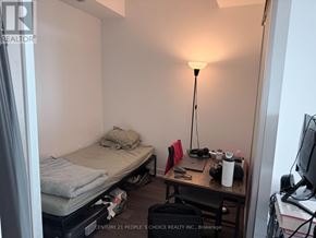 Mississauga (City Centre) condo for rent - A small room with a bed, desk, and lamp.