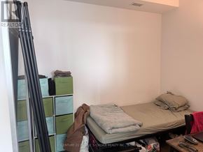 Mississauga (City Centre) condo for rent - A bedroom with a bed, a desk, and a ladder.