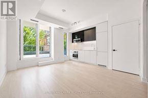 Toronto (Church-Yonge Corridor) condo for rent - A spacious, well-lit kitchen with white cabinets and a large window.
