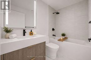 Toronto (Church-Yonge Corridor) condo for rent - A modern bathroom with a white toilet, sink, and bathtub.