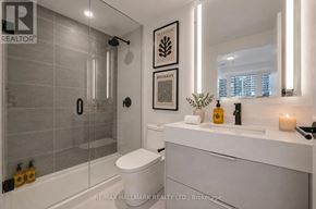 Toronto (Church-Yonge Corridor) condo for rent - A modern bathroom with a glass shower stall and a white toilet.