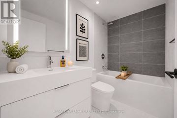 Toronto (Church-Yonge Corridor) condo for rent - A white bathroom with a toilet, sink, and a plant.