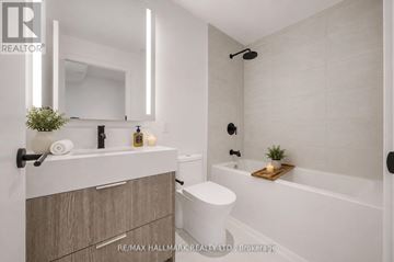 Toronto (Church-Yonge Corridor) condo for rent - A modern bathroom with a white tub, a white toilet, and a white sink.
