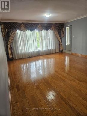 Toronto (Bendale) apartment for rent - A room with wooden flooring and curtains on the window.