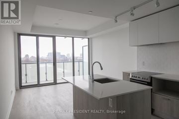 Toronto (Bay Street Corridor) condo for rent - A modern kitchen with a sink and stove top oven.
