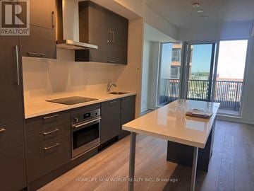 Markham (Unionville) condo for rent - A kitchen with a table and a view of the outside.