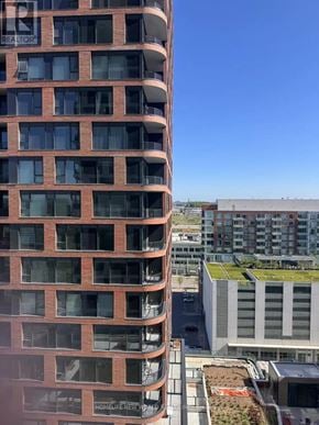 Markham (Unionville) condo for rent - A tall red brick building with many windows and balconies.