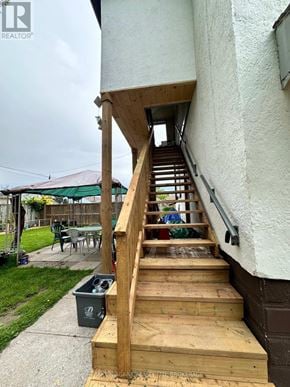 Welland (Lincoln/Crowland) multi-family for rent - A wooden staircase leading to a doorway.