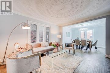 Toronto (Steeles) apartment for rent - A well-lit living room with a glass table and a sofa.