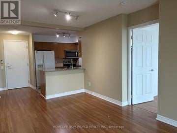 Toronto (Bendale) condo for rent - A kitchen area with a refrigerator, microwave, and oven.
