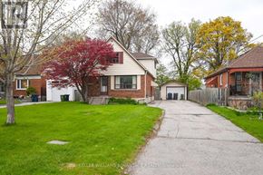 Toronto (Clairlea-Birchmount) apartment for rent - A residential area with houses and a tree with red leaves.