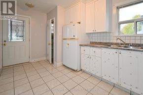Toronto (Clairlea-Birchmount) apartment for rent - A kitchen with white cabinets and a white refrigerator.