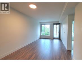 Richmond apartment for rent - A room with wooden floors and white walls, with a sliding glass door leading outside.