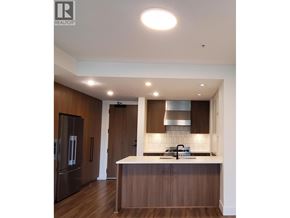 Richmond apartment for rent - A modern kitchen with dark wood cabinets and a white countertop.