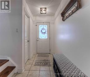 Guelph (Pineridge/Westminster Woods) apartment for rent - A hallway with a door and a bench.