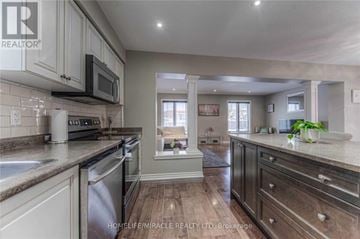 Guelph (Pineridge/Westminster Woods) apartment for rent - A kitchen with a stove top oven and a microwave above it.