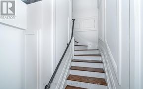 Toronto (Mount Pleasant West) townhouse for rent - A staircase with white walls and wooden steps.