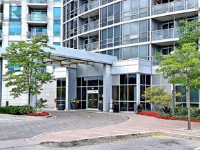 Toronto (Bendale) condo for rent - A modern building with a glass facade and a covered entrance.
