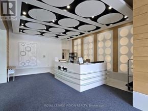 Toronto (Bendale) condo for rent - A reception area with a white reception desk and a logo on the wall.