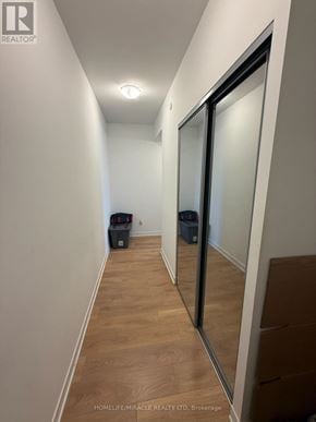 Vaughan (Concord) condo for rent - A hallway with a glass door and a trash can.