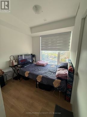 Vaughan (Concord) condo for rent - A bedroom with a bed, a desk, and a window with blinds.