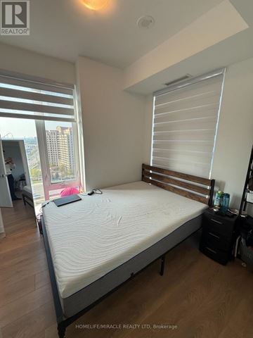 Vaughan (Concord) condo for rent - A bedroom with a large bed and a window with blinds.