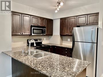 Toronto (Humber Heights) condo for rent - A kitchen with granite countertops and stainless steel appliances.