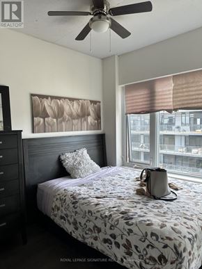Toronto (Banbury-Don Mills) condo for rent - A bedroom with a bed, a ceiling fan, and a window with blinds.