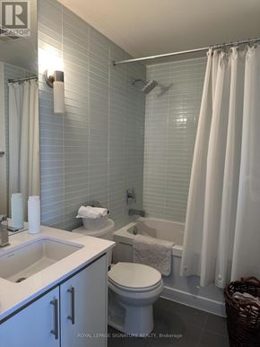 Toronto (Banbury-Don Mills) condo for rent - A white bathroom with a toilet, sink, and shower.