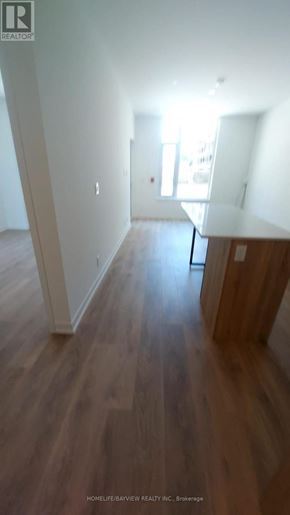 Vaughan (Beverley Glen) condo for rent - A long hallway with wood floors and white walls.