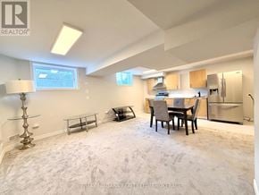 Niagara Falls (Lyons Creek) apartment for rent - A well-lit, empty room with a dining table and chairs, a bench, and a bar area.