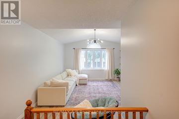 Stratford apartment for rent - A living room with a white couch and a chandelier.