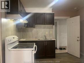 Windsor apartment for rent - A kitchen with a white stove and black cabinets.
