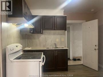 Windsor apartment for rent - A kitchen with a white stove and black cabinets.