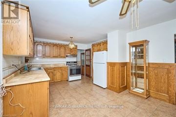 Niagara Falls (Dorchester) apartment for rent - A kitchen with wooden cabinets and a white refrigerator.