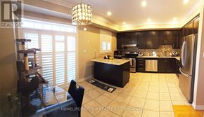 Markham (Cathedraltown) townhouse for rent - A well-lit kitchen with a dining table and chairs.