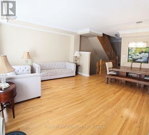 Markham (Cathedraltown) townhouse for rent - A living room with a white couch and wooden floors.