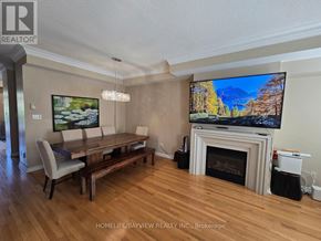 Markham (Cathedraltown) townhouse for rent - A living room with a fireplace and a television on the wall.